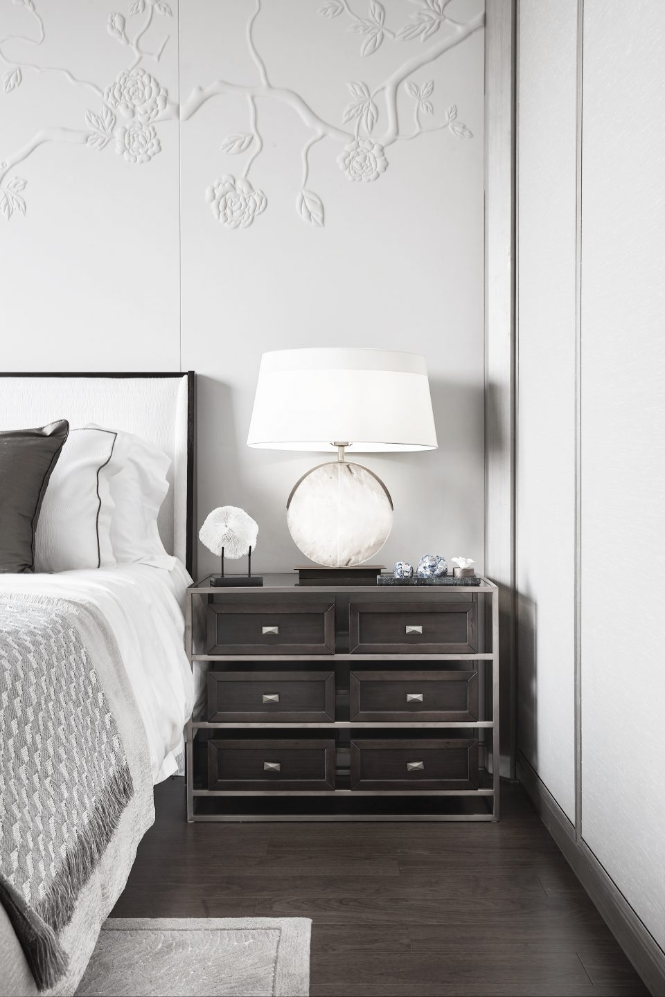 Master bedroom detail shot with textured wall and sideboard
